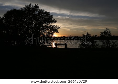 The view of the park bench at sunset
