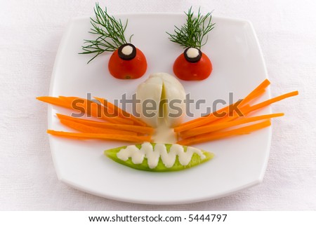 Vegetable face on a white plate