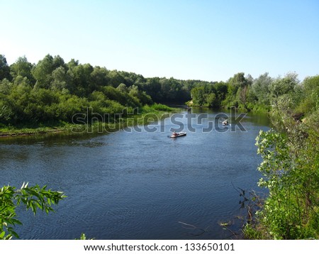 beautiful landscape with river and canoe with people on it