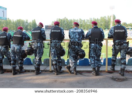 Lvov, Ukraine - CIRCA AUGUST 2013: policemen standing guard over order in the stadium during football match
