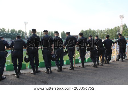 Lvov, Ukraine - CIRCA AUGUST 2013: policemen standing guard over order in the stadium during football match