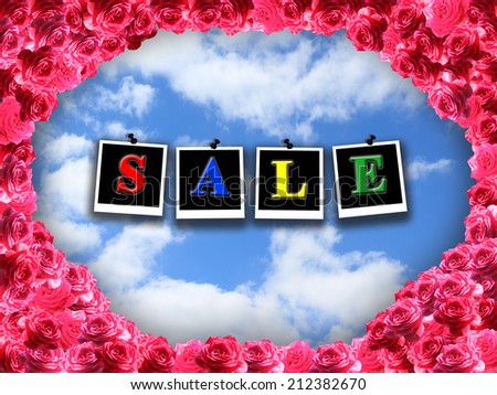 inscription sale on the blue sky background with red roses