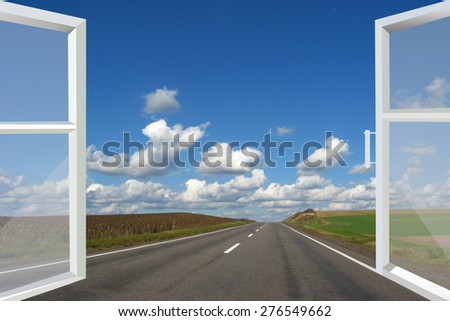 window opened to the asphalted road and cloudy blue sky