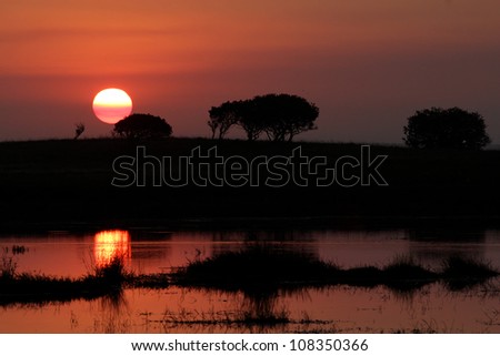 Sunset over Isimangaliso Hide. Photo taken at Mafazana Hide in Isimangaliso Wetland Park. Kwazulu Natal. South africa. A world heritage site. Silhouette.