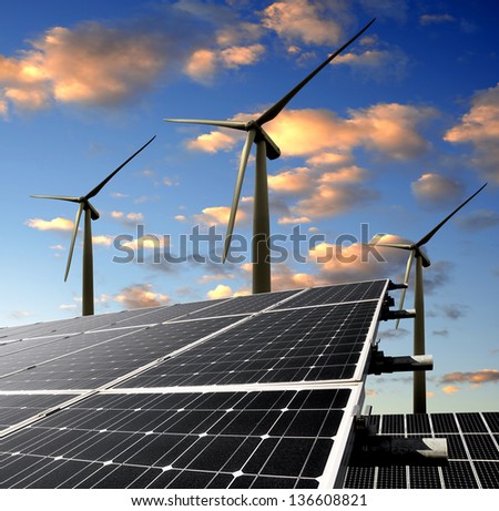 solar energy panels and wind turbine in the sunset