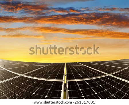 Solar energy panels against sunset sky. Green energy.