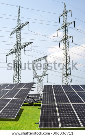 Solar panels with electricity pylons. Green energy concept.