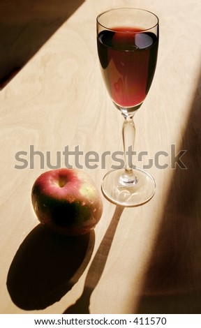 Glass of red French wine and an apple.