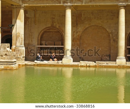 CITY OF BATH, ENGLAND - JULY 6: Tourists at the ancient Roman Bath Museum, West England, July 6, 2009. The Baths are a major tourist attraction and receive more than one million visitors a year.