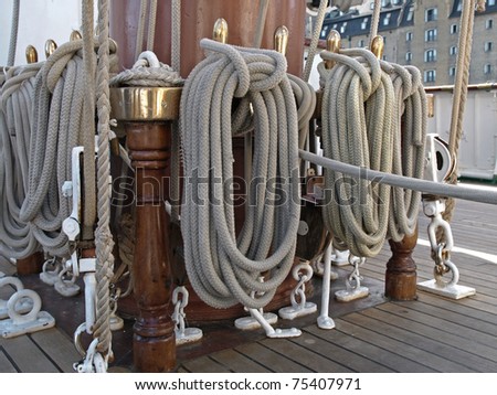 old and used ships sail ropes hanging on deck