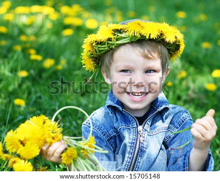 Happy kid with diadem of dandelions
