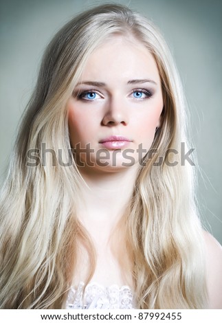 Beautiful young girl with long white hair and shiny skin
