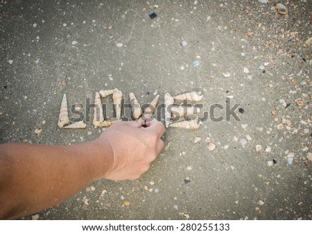man do love word with seashell on the sand