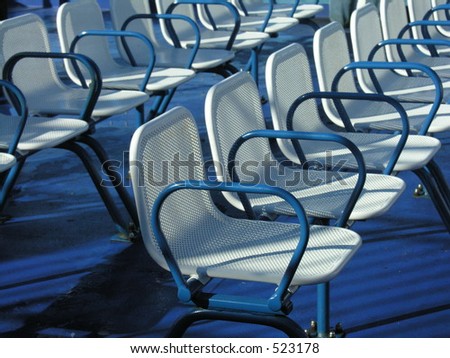 A row of empty seats on the upper deck of a ferry.