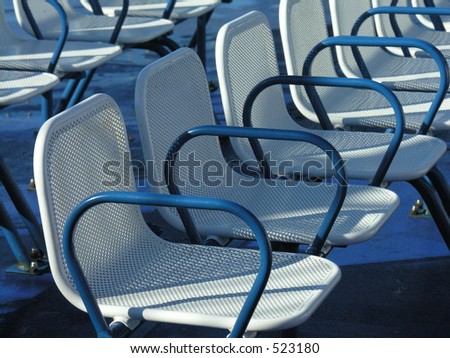 A row of empty seats on the upper deck of a ferry.