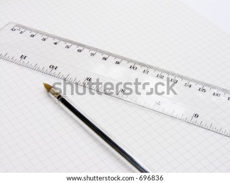 A biro pen and a ruler on squared paper