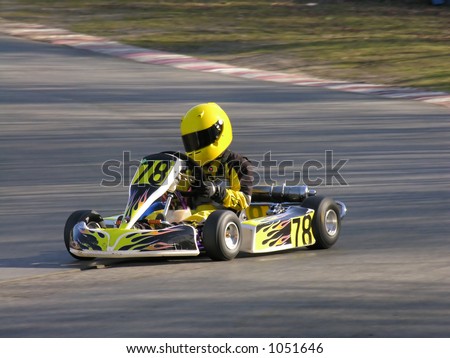 A racing yellow and black cadet go kart.