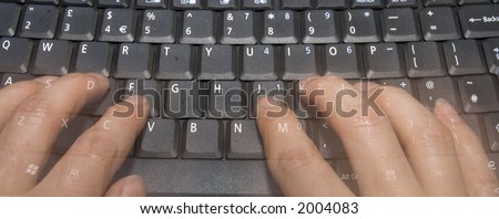 Ghostly hands typing as a blur on a black keyboard