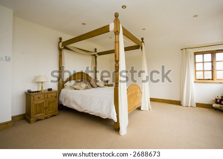 Spacious bedroom minimialistic with four poster bed