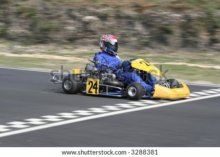 A yellow gearbox go kart crossing the finish line