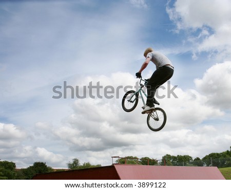 A stunt rider doing high jumps on a bmx bicycle