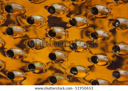 Abstract pattern of orange colour made with a cheese grater
