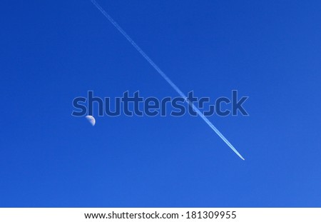Airplane and moon on the blue sky