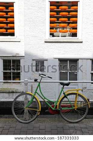 DELFT, NETHERLANDS - APRIL 2: Bicycle in front of shop with cheese in town Delft on April 2, 2014 in Delft
