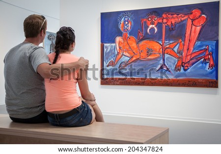 BRATISLAVA, SLOVAKIA - JUN 28: People looking at the picture in the museum of new art Danubiana in city Bratislava on Jun 28, 2014 in Bratislava