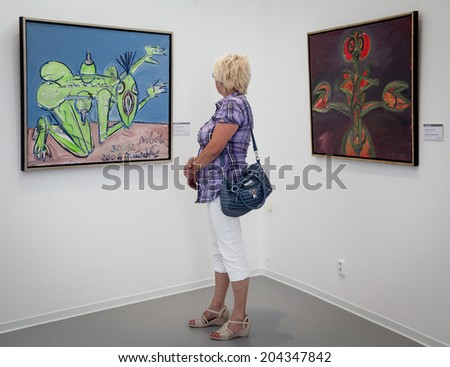 BRATISLAVA, SLOVAKIA - JUN 28: Woman looking at the picture in the museum of new art Danubiana in city Bratislava on Jun 28, 2014 in Bratislava