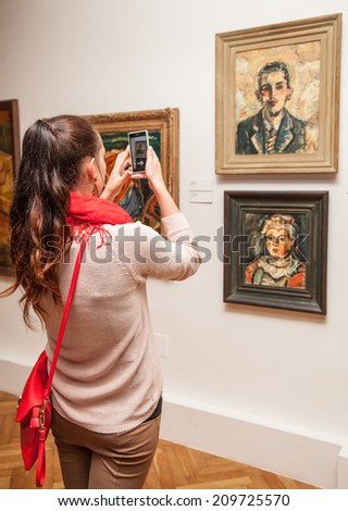 RUZOMBEROK, SLOVAKIA - JULY 22: Girl looking at Fulla\'s painting in Gallery of Ludovit Fulla on July 22, 2014 in Ruzomberok