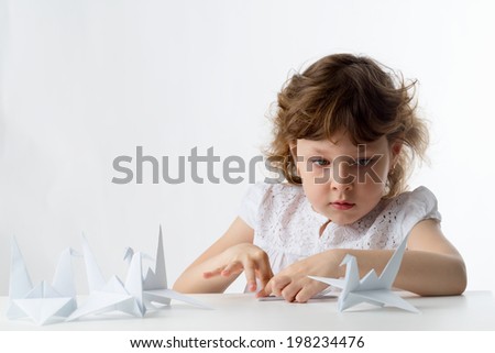 Little Girl with Paper Cranes