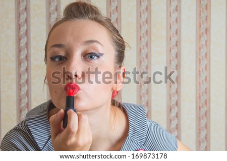young woman in the pin up style colors lipstick