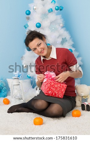 young business woman open christmas gift