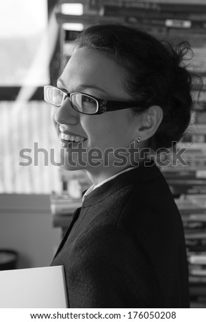 black and white portrait smiling girl in glasses like teacher