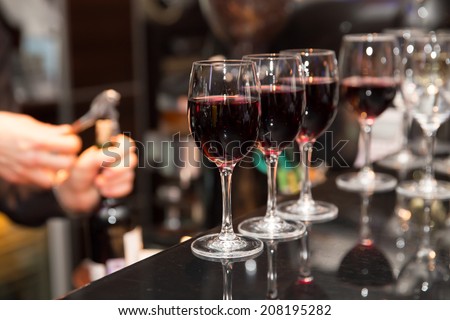 glasses with red wine on bar counter