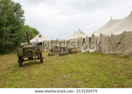 white big army tent and field kitchen