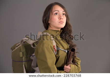 portrait pensive brunette  in uniform of the Soviet army and  parachute