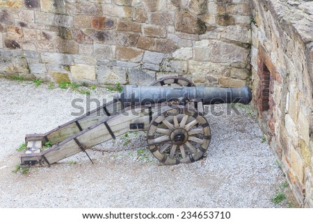 Eger, Hungary - September 16, 2014. Old cannon on wooden wheels in  stone wall