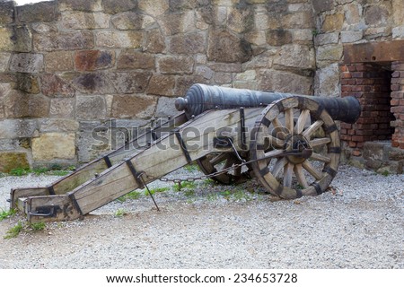 Eger, Hungary - September 16, 2014. Old cannon looks loophole in the stone wall