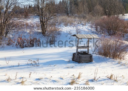 old wooden well in the winter forest
