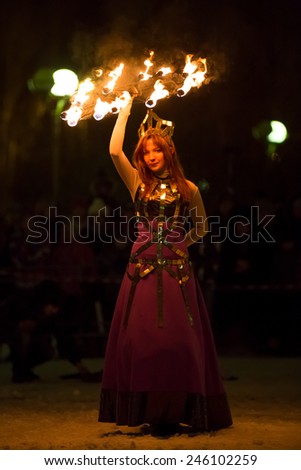 Perm, Russia - January 17, 2015. Woman in costume of queen dances with fiery fan under head