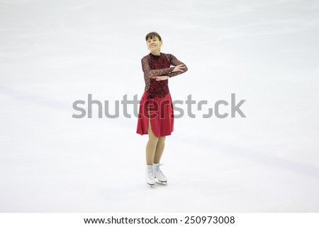 Perm, Russia - January 31, 2015. Figure skating competitions among fans. Mature woman standing on the ice skating