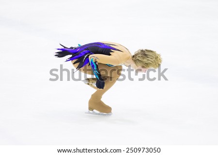 Perm, Russia - January 31, 2015. Figure skating competitions among fans. Blonde makes an element of rotation on one foot skating