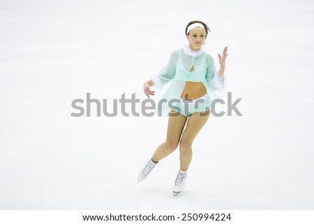 Perm, Russia - January 31, 2015. Figure skating competitions among fans. Young woman  in sexy pale blue suit dancing on skates