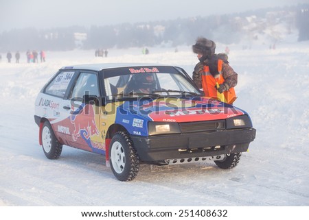 Dobryanka, Russia - February 7, 2015. Urban ice race. Machine with bright labels and the referee before the start