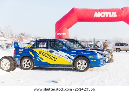 Dobryanka, Russia - February 7, 2015. Urban ice race. Sports car with stickers on the ice city races