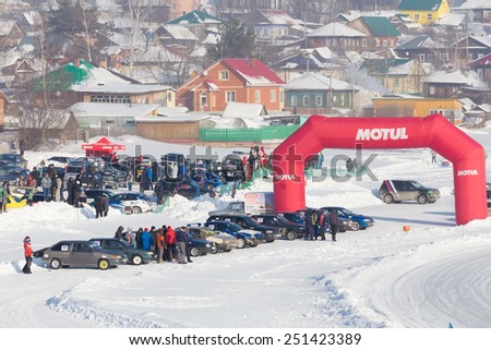 Dobryanka, Russia - February 7, 2015. Urban ice race. Red Gate and a lot of sports cars in winter top view