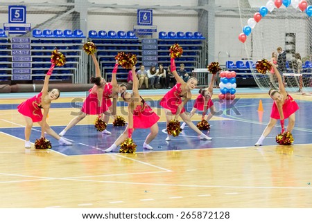 Perm, Russia - March 28, 2015. Championship Perm Krai on cheerleading. Girl in red suit dancing on cheerleading championship