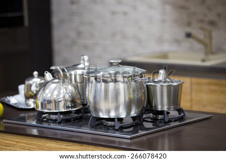 kettle, stainless steel pan on gas cooker top view